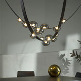 Lustre suspendu design à sangles de cuir et globes en verre
